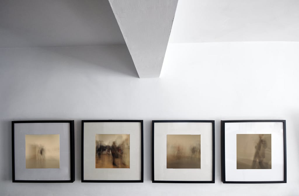 Series of four photo prints of people moving through a gallery