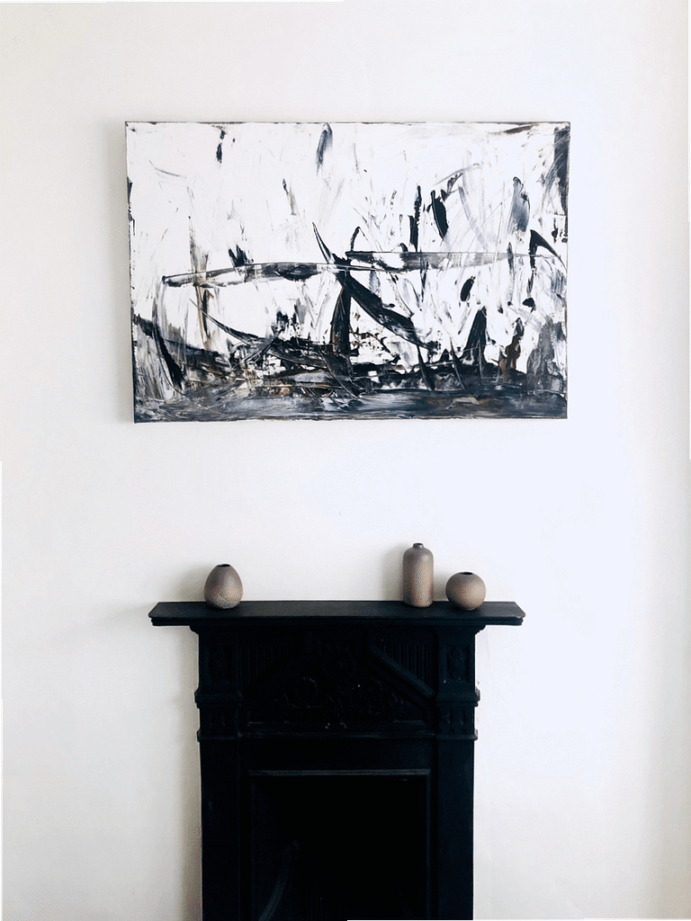 birds nest painting hanging above fireplace
